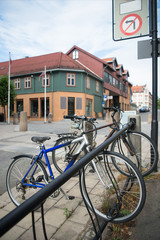 Wall Mural - parked bicycles with building behind at city street, Hamar, Hedmark, Norway