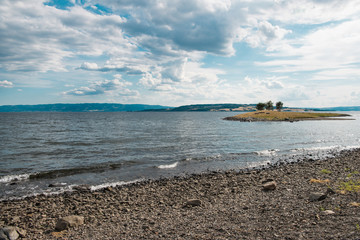 Wall Mural - scenic view of Mjosa lake with small island and cloudy sky, Hamar, Hedmark, Norway