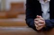© waranyu - woman praying in morning, hands folded in prayer