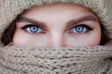 Close-up Portrait Of A Woman In A Scarf And Hat With Beautiful Blue Eyes