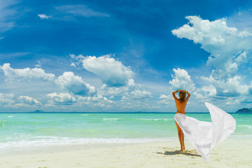 Cute woman relaxing on the summer beach.