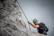 © lightpoet - Male climber on a via ferrata - climbing on a rock in Swiss Alps