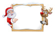 Santa Claus and Reindeer Christmas cartoon characters in a pointing at a snow covered sign