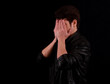 © buraktumler - Man hiding his face on black background