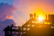 © JU.STOCKER - Silhouette of Engineer and worker on building site, construction site with clipping path at sunset in evening time.