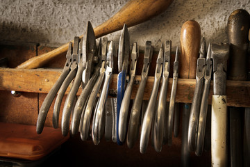 Wall Mural - different goldsmiths pliers and tools on the jewelry workplace