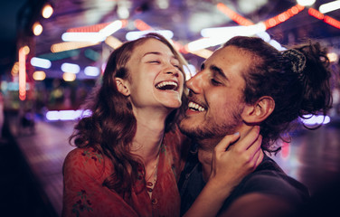 Young happy couple/ Young happy couple enjoying themselves at the amusement park