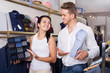 © JackF - Two young customers selecting shirt and tie
