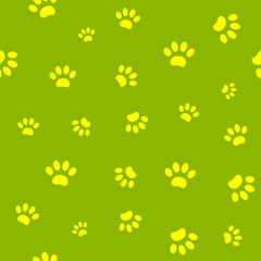 Wall Mural - Seamless pattern of yellow paw prints on green background.