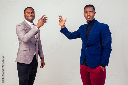 Fotografía two handsome young Afro American businessman in classic suit rejoicing and exult