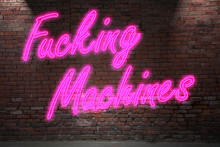 Fucking Machines Neon on brick wall