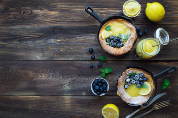 Wall Mural -  Dutch Baby pancake with lemon curd and blueberries