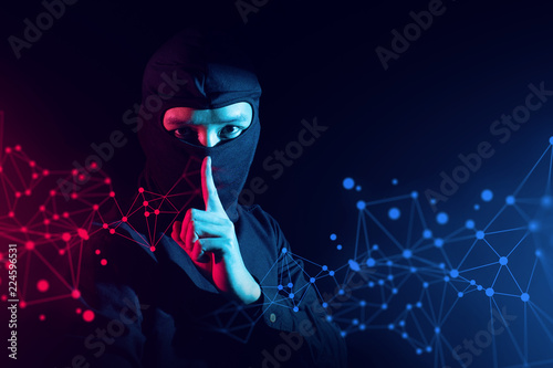 Fotomural hacker guy in ninja costume with red and blue light in security hack to digital