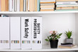 Work Safety and Safety Procedures concept. document folders and organizers, white book shelf