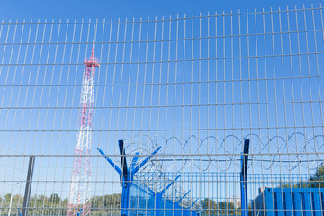 Area with barbed wire. Dangerous area. Private territory. Energy tower