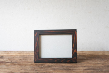 Wood frame photo old vintage put on grunge wooden table desk design.