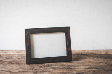 Wood frame photo old vintage put on grunge wooden table desk design.