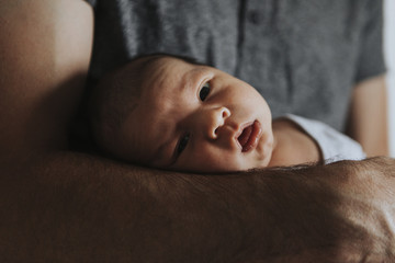 Wall Mural - young father holding his baby