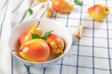 Poster - organic pears laying down on a lightly dotted kitchen cloth