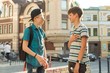 © Valerii Honcharuk - The friendship and communication of two teenage boys is 13, 14 years old, city street background