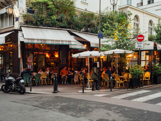 Wall Mural - cozy street with tables of cafe in paris, france
