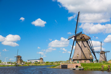 Wall Mural - Famous windmills in Kinderdijk village in Holland. Colorful spring rural landscape in Netherlands, Europe. UNESCO World Heritage and famous tourist site.