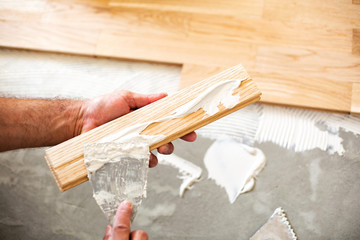 Wall Mural - Applying of parquet glue on a floor plate