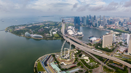 Fototapete - Aerial view of the Singapore landmark financial business district at sunrise scene with skyscraper and over clouds. Panorama of Singapore downtown.