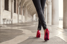 Woman Walking In Black Pants And Red High Heels