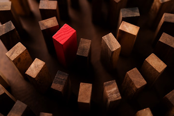 red wooden block with others wooden block in a row leadership ideas concept