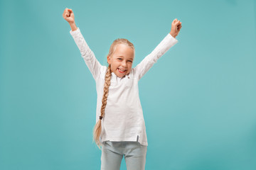 I won. Winning success happy teen girl celebrating being a winner. Dynamic image of caucasian female model on blue studio background. Victory, delight concept. Human facial emotions concept. Trendy