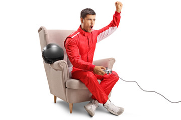 Wall Mural - Racer sitting in an armchair, playing video games and gesturing with hand