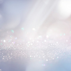 Poster - Winter gentle sparkle snowy blurry background in light blue pink tones. Christmas backdrop defocused with beautiful light, abstract shiny snowflakes flake of snow in blur, copy space.