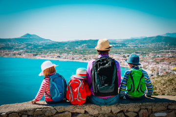 father with kids travel together, looking at scenic view