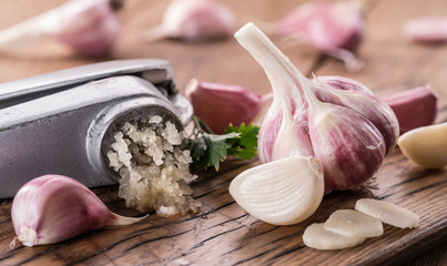 Wall Mural - Garlic bulb and garlic cloves  on the wooden table.