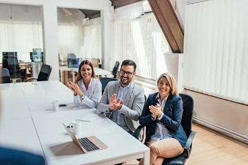 Wall Mural - Coworkers applauding after presentation. Viewpoint.