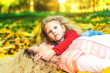 Mother with her little daughter have fun in the park.