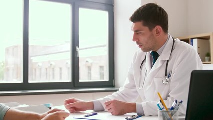 Sticker - medicine, healthcare and people concept - doctor showing cardiogram and giving drug pills to male patient at hospital