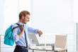 © New Africa - Young handsome businessman holding fitness bag in office. Space for text