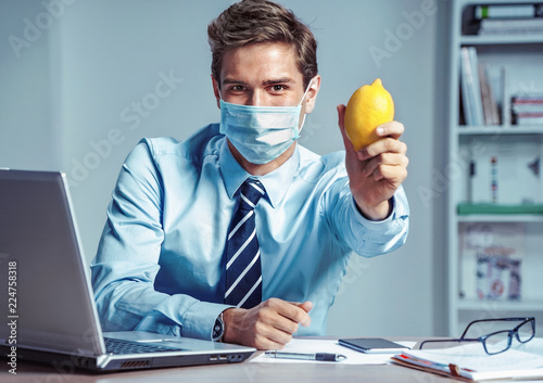 Healthy worker at the office holding lemon Tableau sur Toile