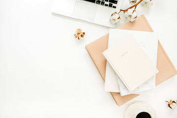Wall Mural - Woman home office desk with laptop, notebook, coffee cup, cotton branch on white background. Flat lay, top view minimal blogger workspace.