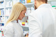 © Karanov images - Colleagues pharmacists and chemists working at pharmacy drugstore