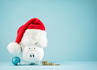 Christmas Holiday piggy bank wearing santa hat