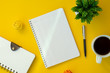 © Constantine - Notebook with text copy space on yellow working desk. Elegant minimal work space flat lay.