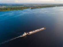 Aerial View Carrier Ship On River Volga. Cargo Ship Photo From Drone.