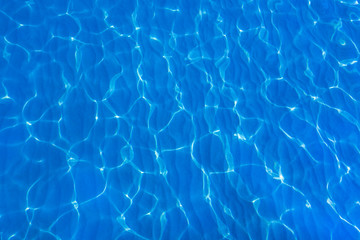  Blue and bright ripple water, surface water in swimming pool or sea. Beautiful motion gentle waves.