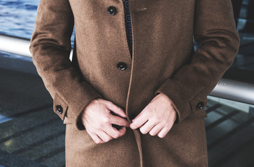 the man undoes a coat