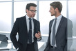 © ASDF - business partners discuss standing in the office