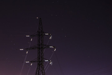 power lines in the backlight of the moon in the night star sky