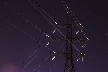 power lines in the backlight of the moon in the night star sky